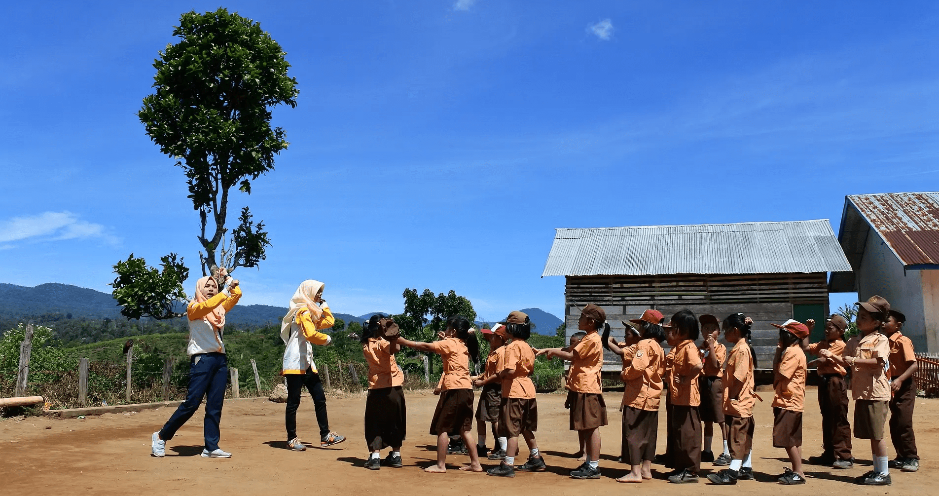 Happy students and teachers in a line outside